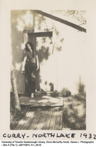 Ethel Curry in doorway of cabin at North Lake