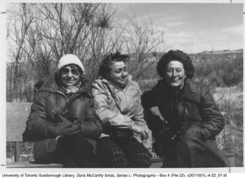 Doris, Barbara, and Nan seated on bench, in black and white