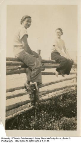 Doris and a friend sitting on fence