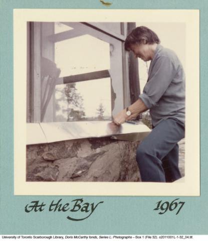 Doris repairing window at Georgian Bay cottage